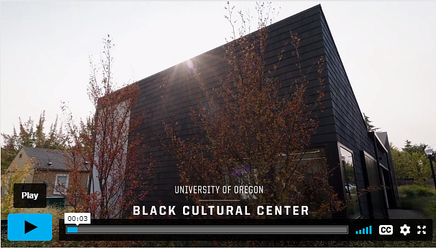 Front of the Black Cultural Center with trees in front and the sun behind