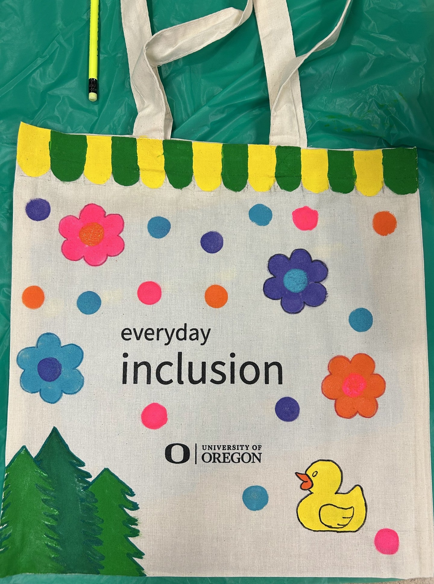 Everyday Inclusion tote bag with flowers, circles, trees, and a duck