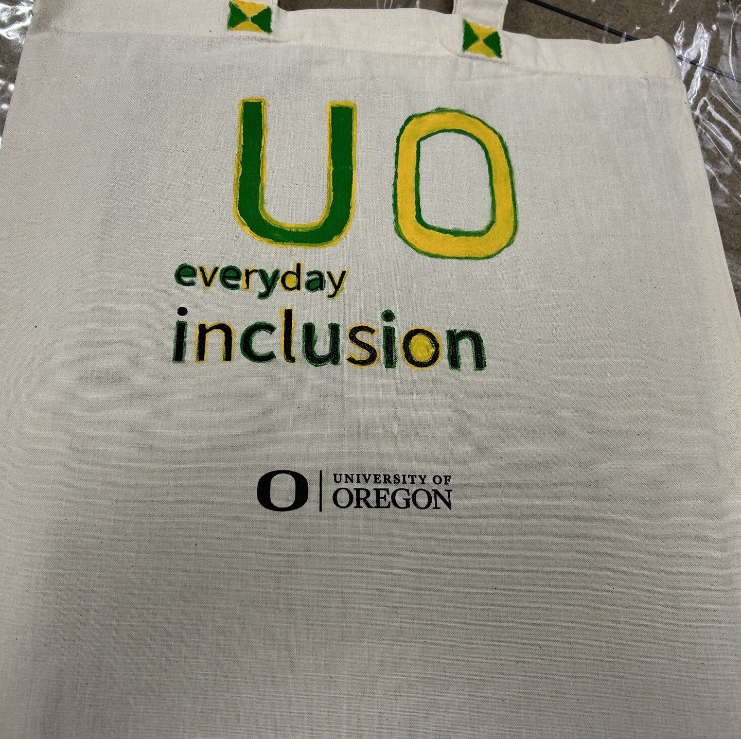 Everyday Inclusion tote bag with UO in green and yellow