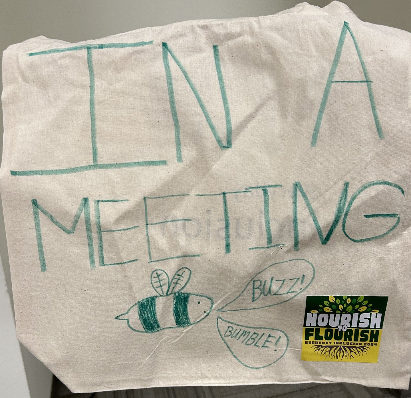 Everyday inclusion bag with the words IN A MEETING and a bee