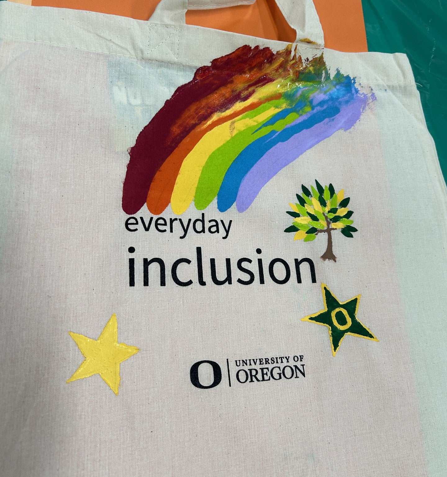 Everyday Inclusion bag with a rainbow, two stars, and a tree