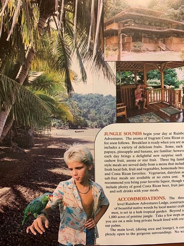 A brochure shows palm trees on the beach with a young blond boy (Jove) and a parrot. Also: Rainbow Adventures Lodge information.
