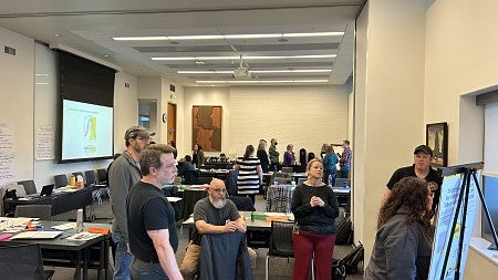 Situational Leadership groupwork - people stand and sit while one writes on a flipchart
