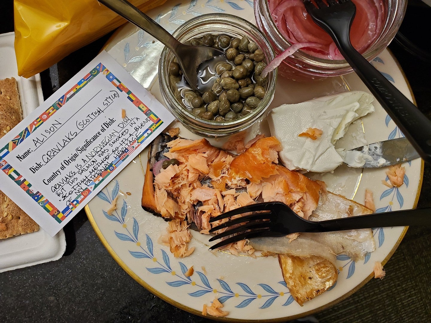 Smoked salmon, capers, cream cheese, and capers by a card that reads "Gravlaks Scottish Style"